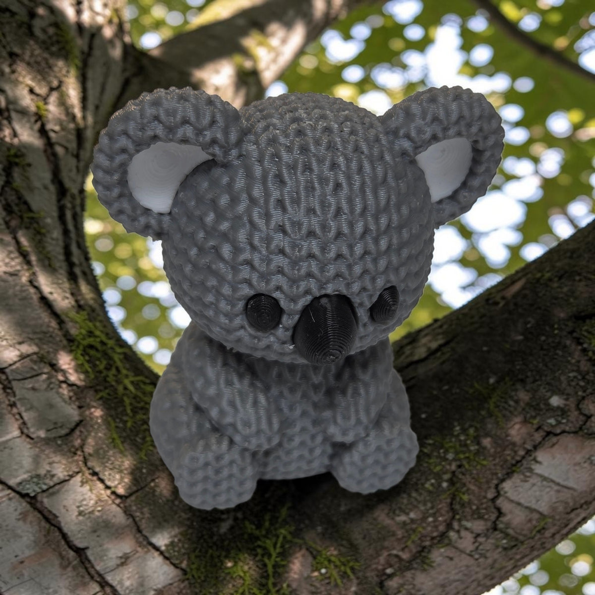 HPHobbies 2.25-inch grey 3D printed faux knit koala figurine sitting on a tree branch with a crochet-like texture.