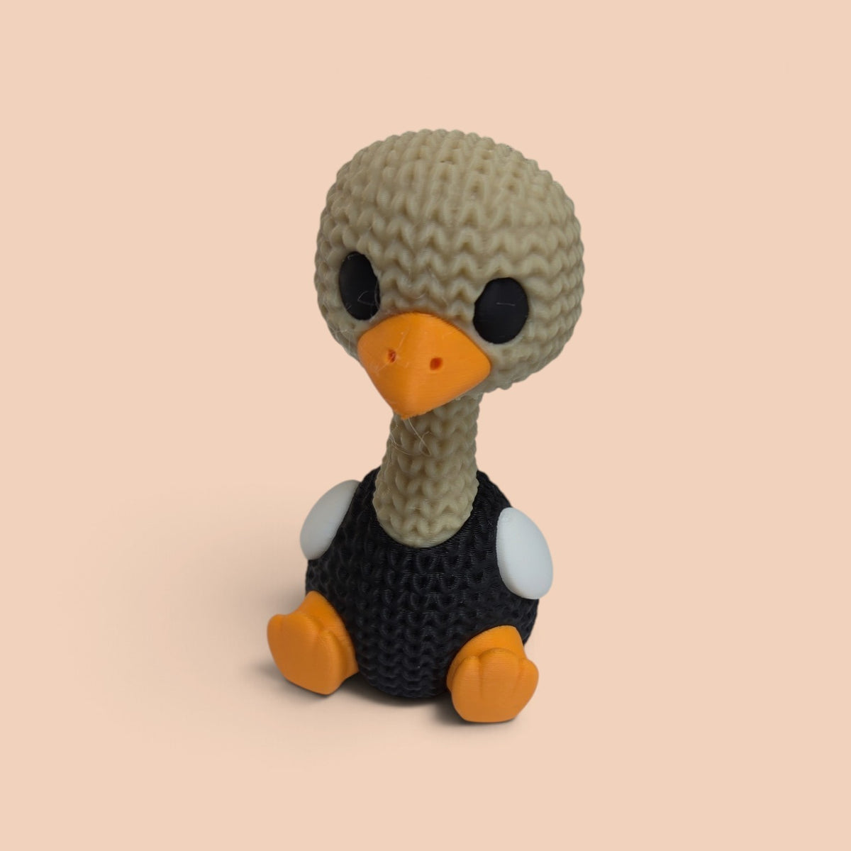 HPHobbies 2.25 inch 3D printed faux knit ostrich figurine with a beige head, black body, and orange beak and feet.