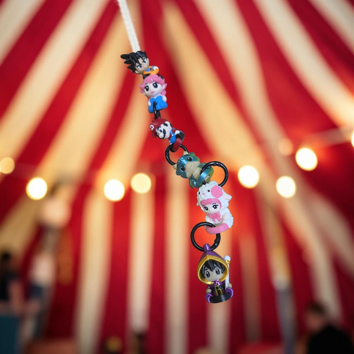 HPHobbies Linklet collectible figurines snapped together as a colorful chain against a red and white circus tent